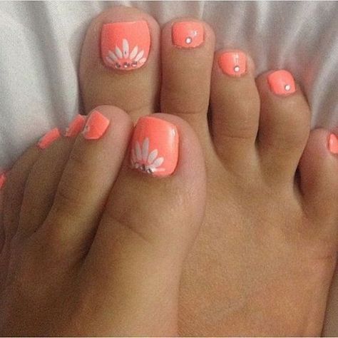 Coral Toe Nail with White Flowers on.