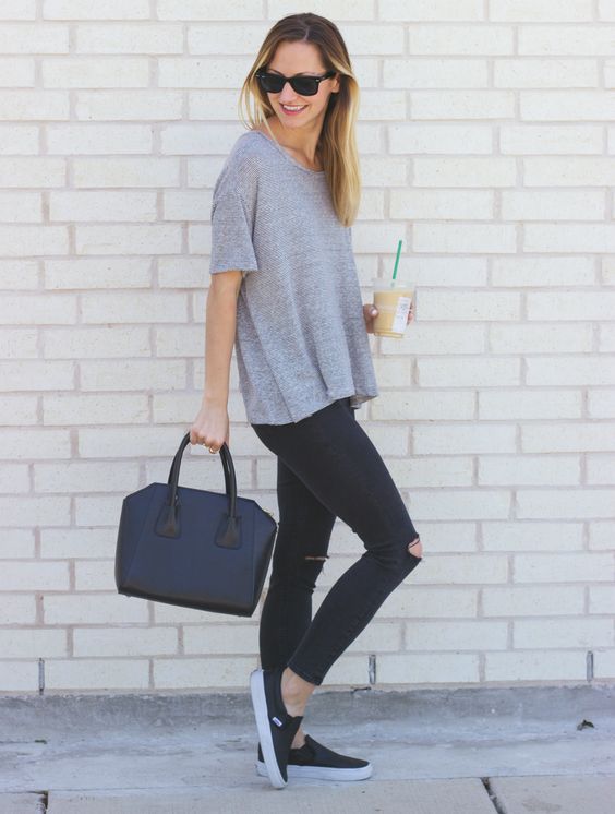 ripped jeans, a grey tee and black sneakers