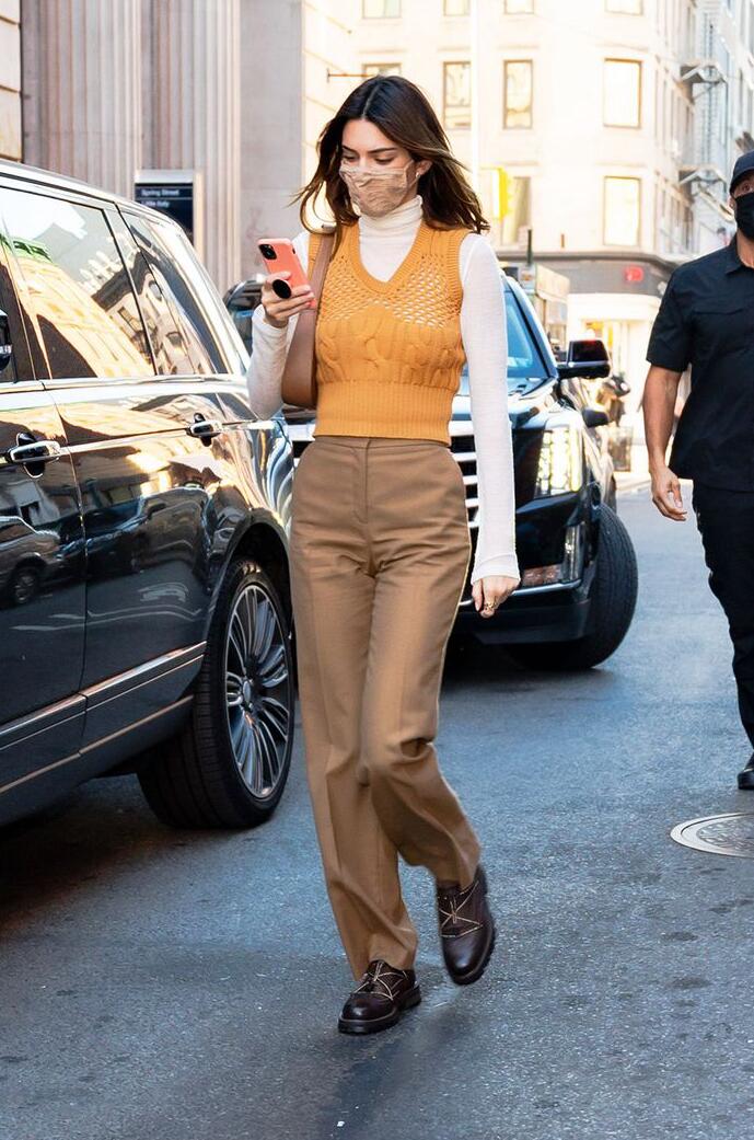 Kendall Jenner with orange sweater vest
